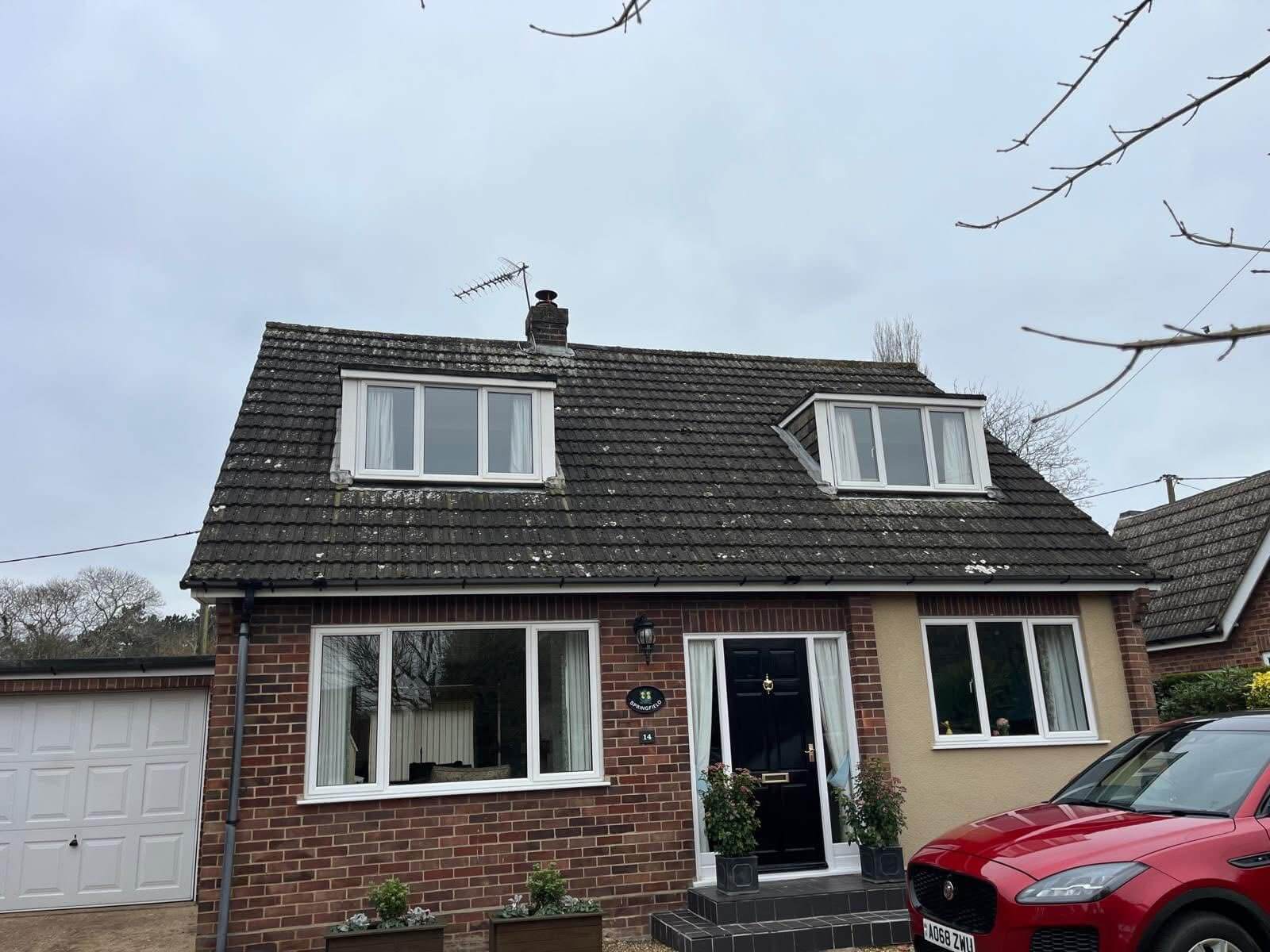 Original front elevation showing worn timber cheeks and old windows before a modern exterior insulation upgrade in Little Melton. By Norfolk Exterior Solutions.